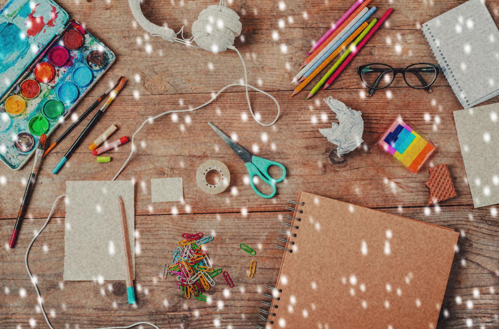 table of art and craft supplies with snowfall effect