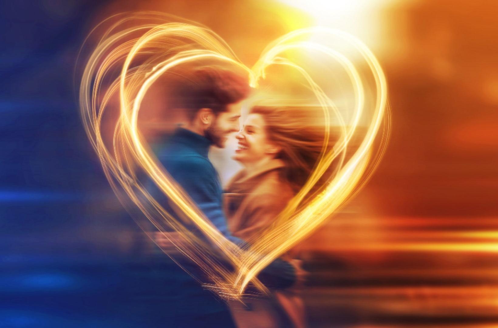A man and a woman in a heart made of light. The image is intentioanlly blurred.