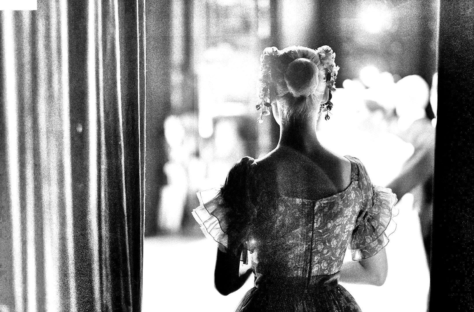 Black and white image of an actress waiting to go on stage