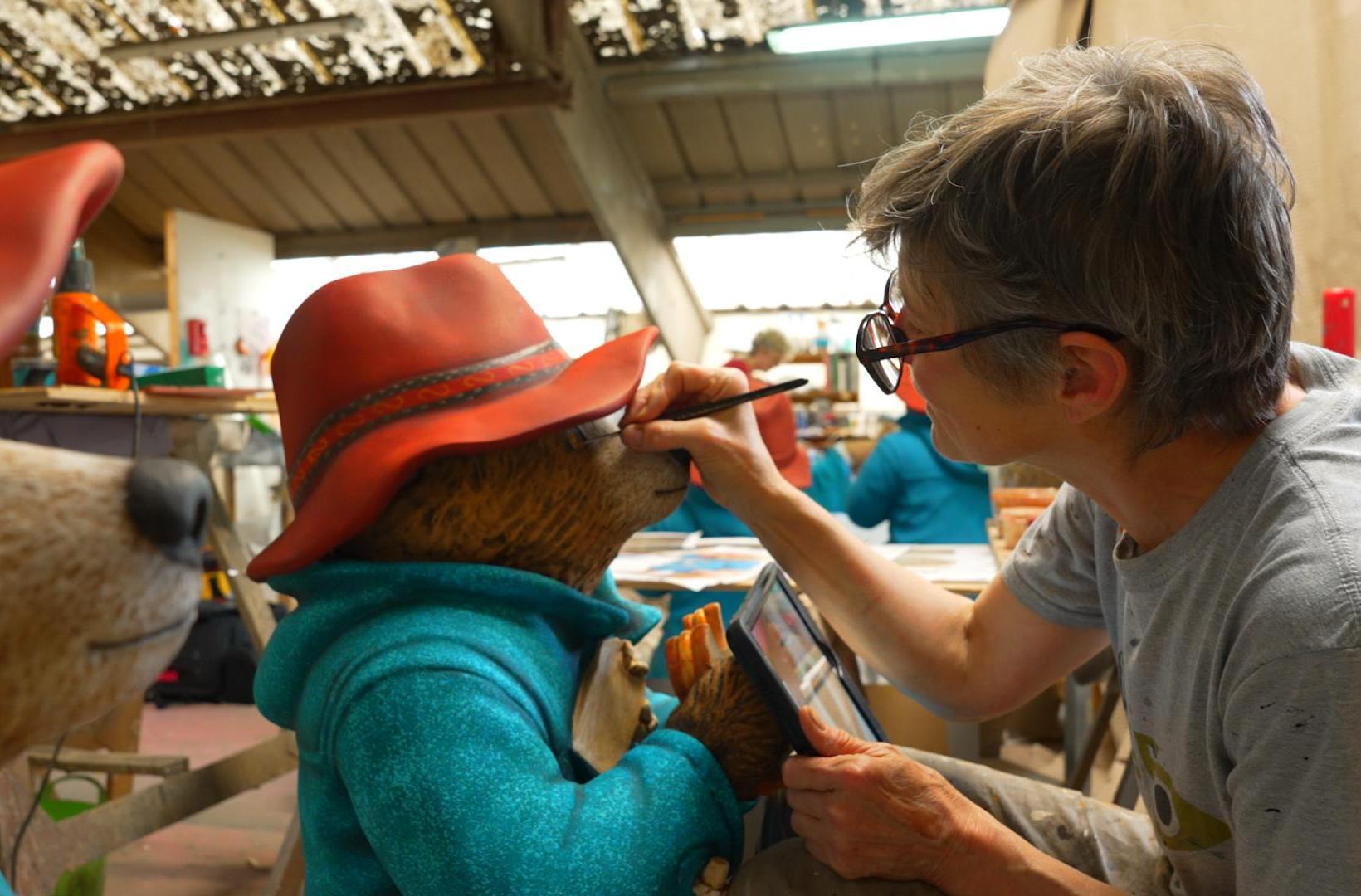 artist painting a model of Paddington Bear