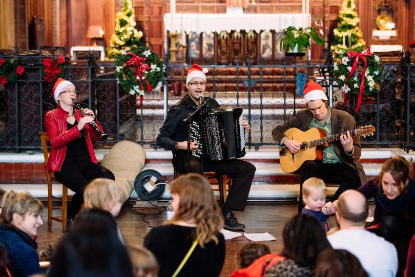 Trio of musicians performing at a festive concert
