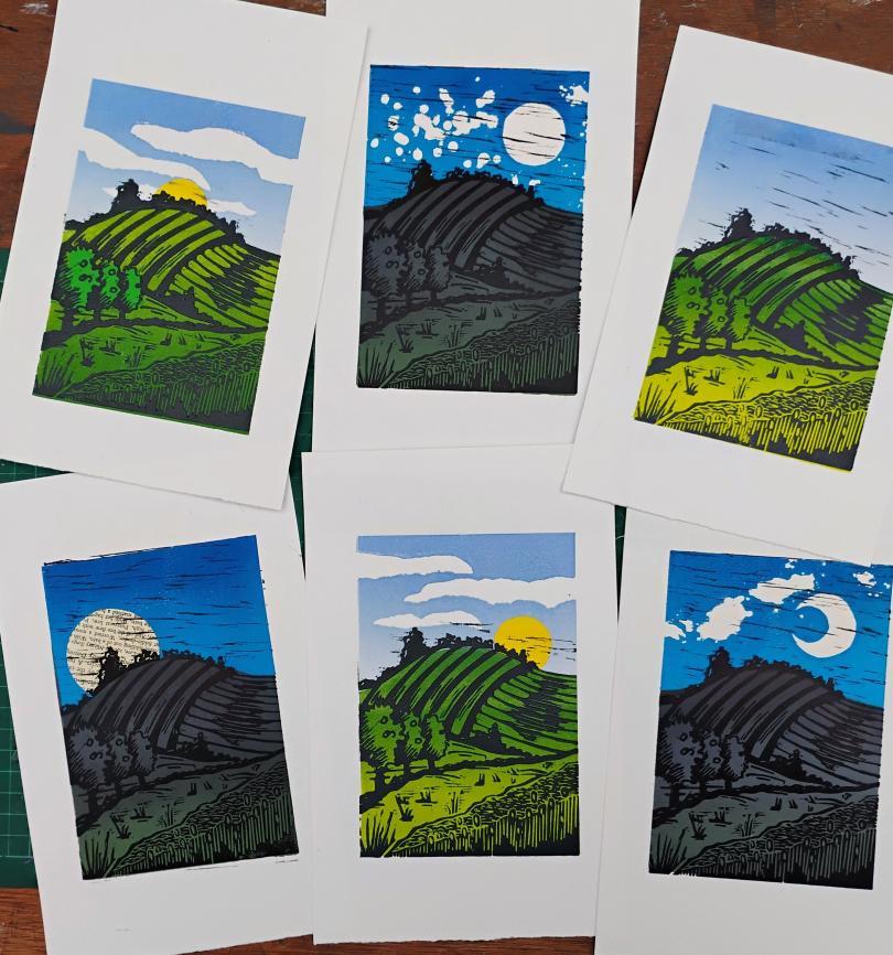 Coloured lino print landscapes on paper