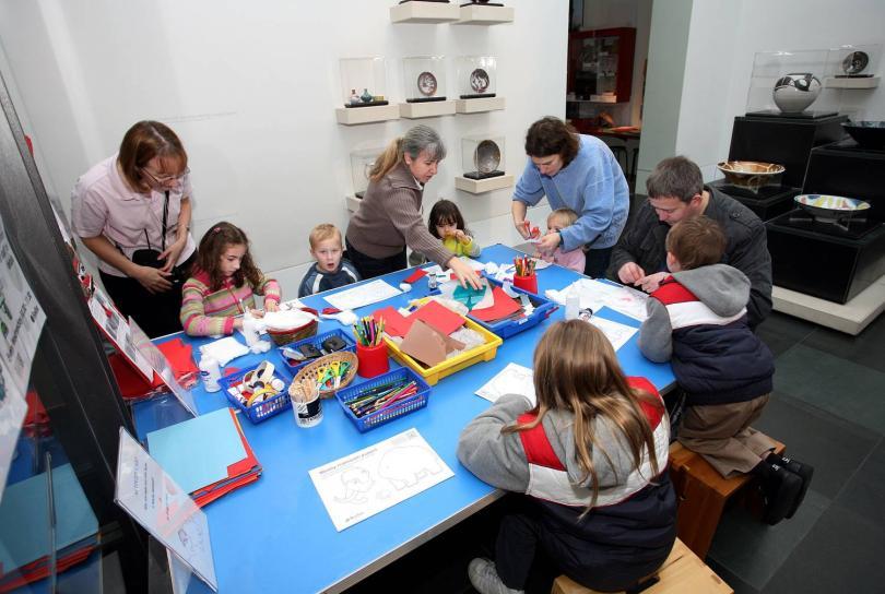 Children colouring at activity cart