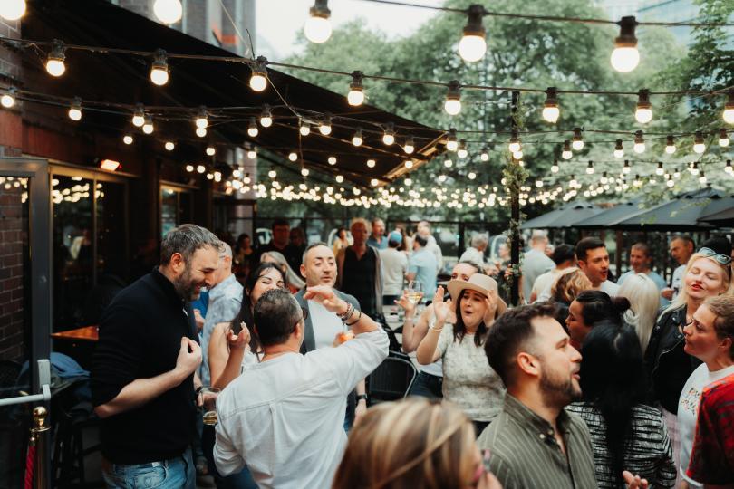 happy crowd in the outside space at Vino.Vita
