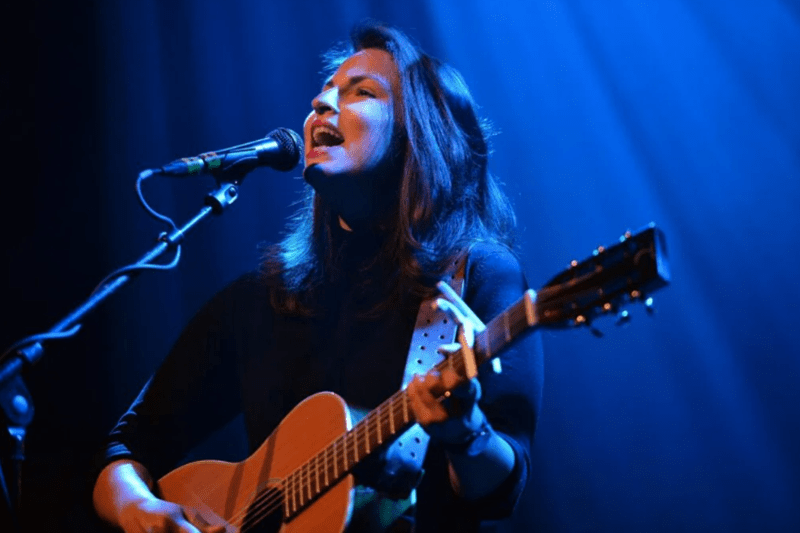 Danni Nicholls playing guitar