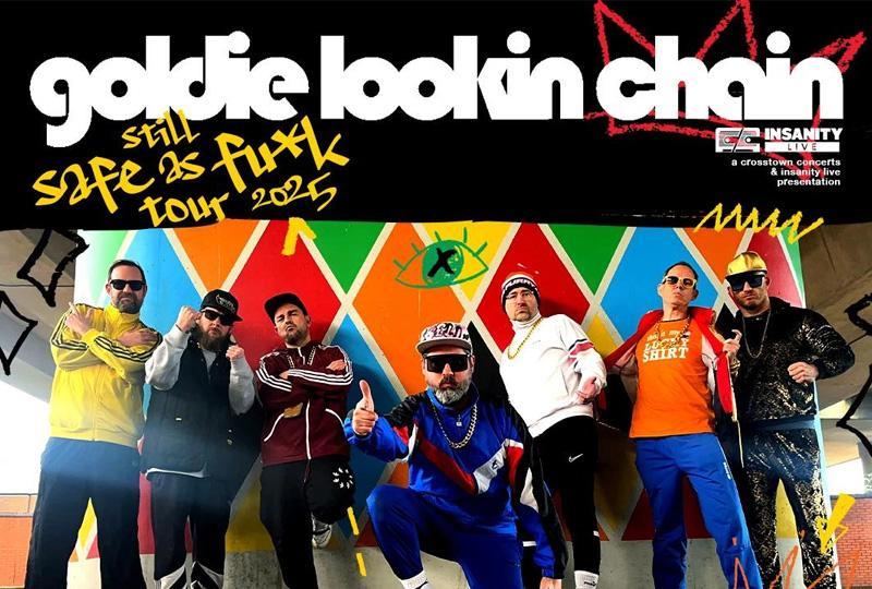 Goldie Lookin Chain band members in 80s hip-hop outfits posing against a coloured wall