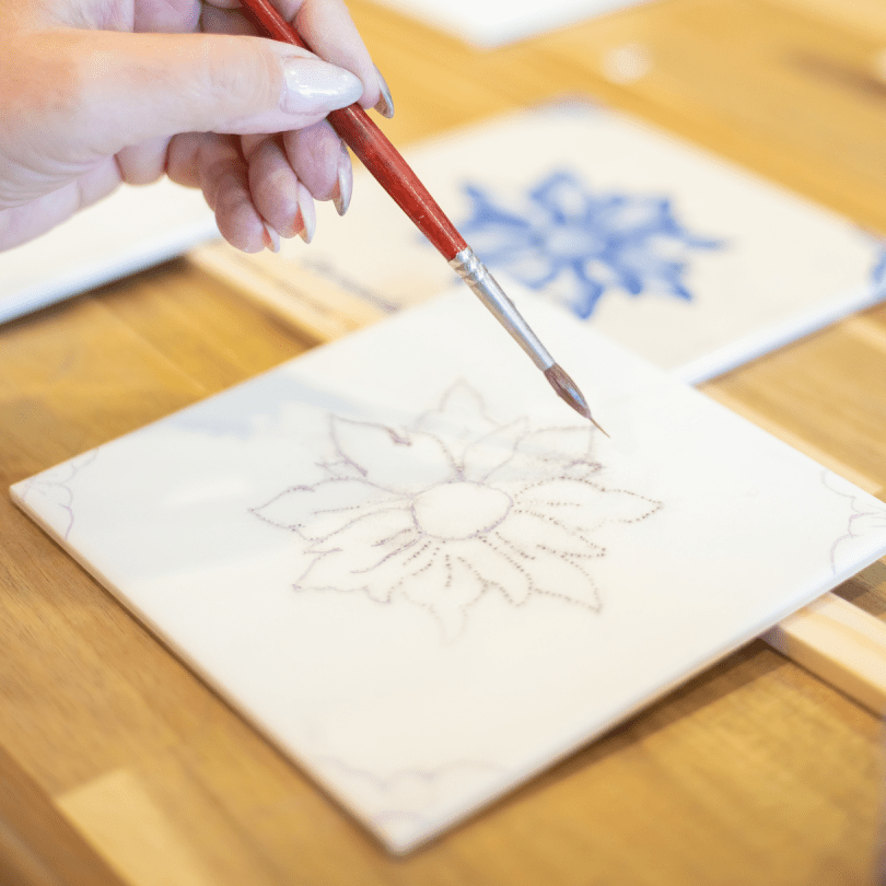 Hand painting a tile