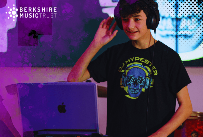 Young musician producing music on an Apple Mac and Berkshire Music Trust logo