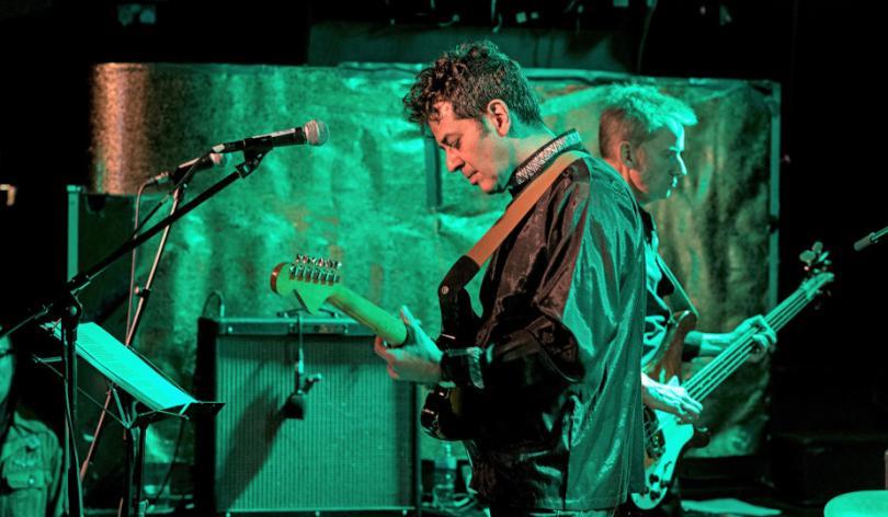 Members of the Monochrome Set performing on stage