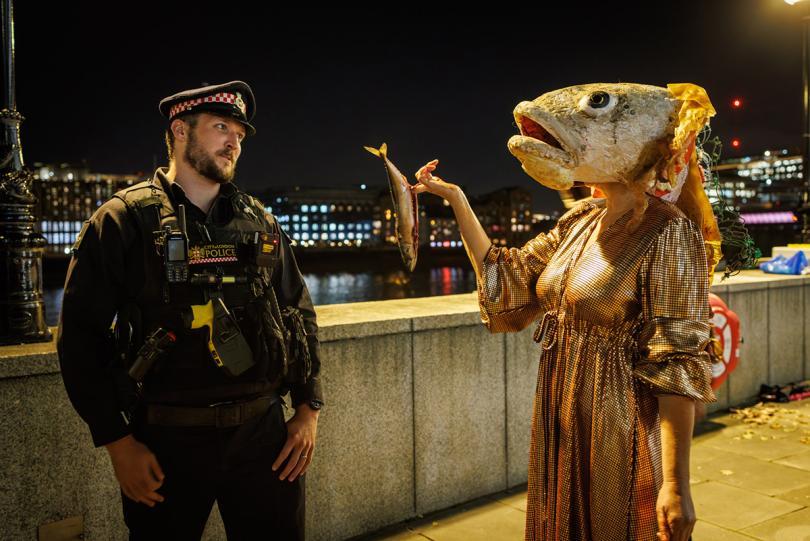 costumed performer with police officer