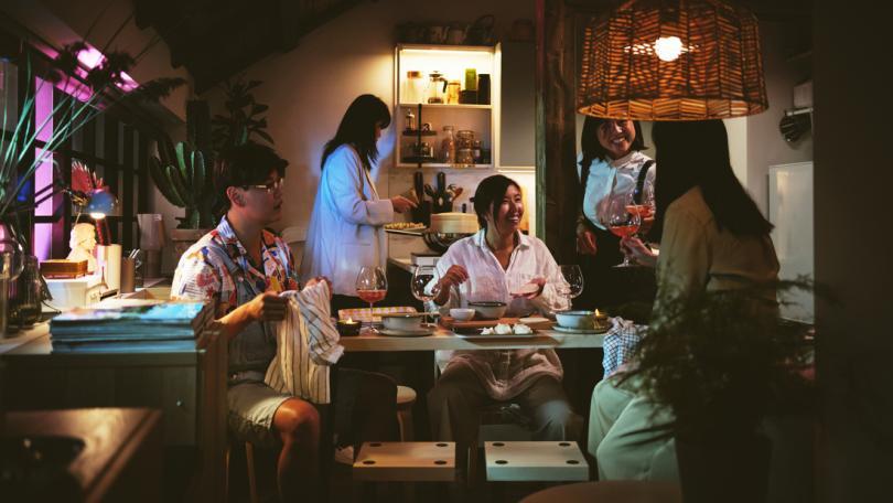 Friends gathered eating and drinking in their Pjs