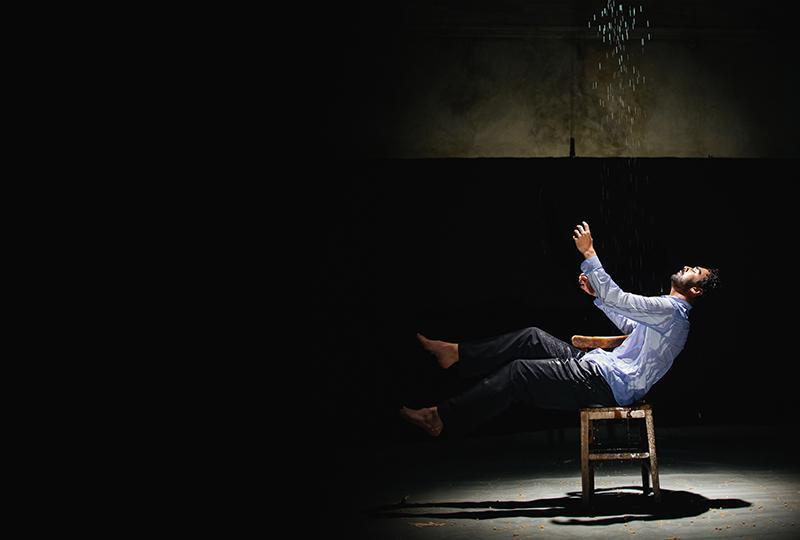 Production photo of Sharif Afifi performing Paradise Lost (lies unopened beside me).