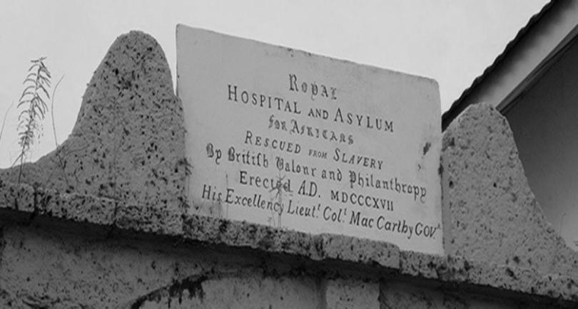 Inscription stone above the gateway to The King's Yard, Freetown, Sierra Leone reads "ROYAL ASYLUM AND HOSPITAL FOR THE AFRICANS RESCUED FROM SLAVERY BY BRITISH VALOUR AND PHILANTHROPY"