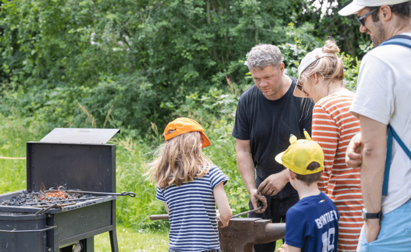 Blacksmith and families in the MERL garden