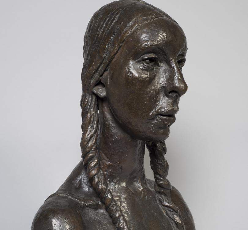 Bust of woman  with plats