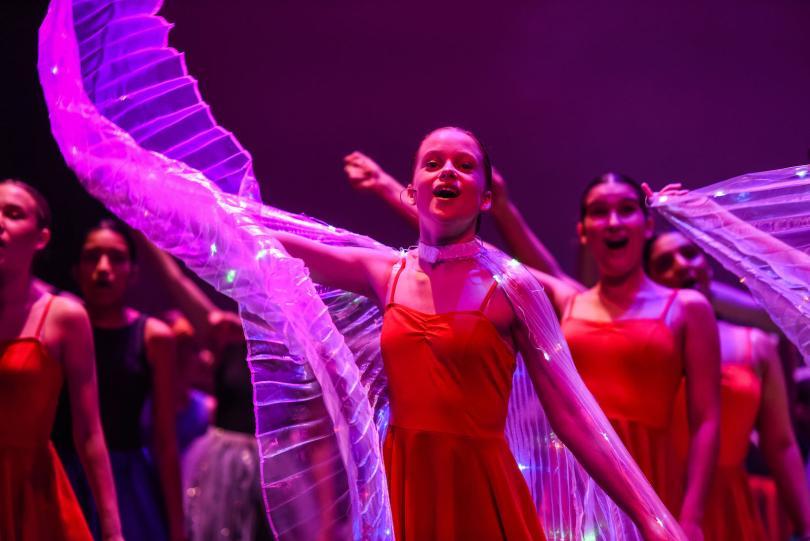 Girl singing and dancing on stage