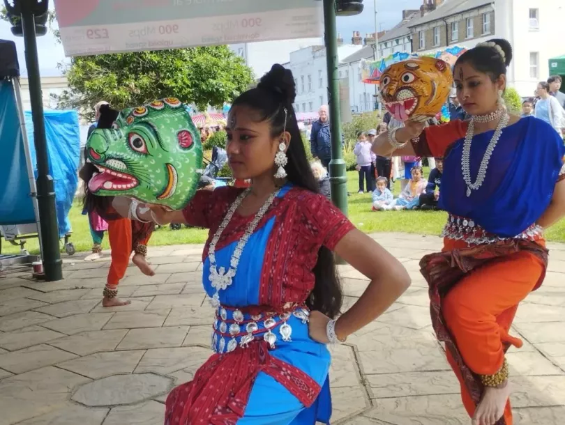 Classical Indian dancers with prop heads