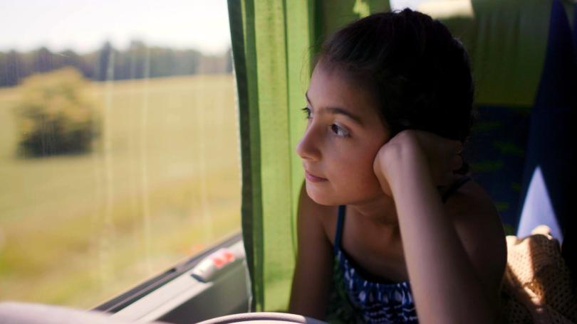 Girl looking out of train window 