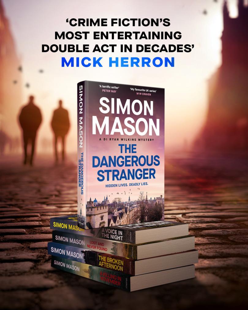 Picture of the Simon Mason book The Dangerous Stranger. The book is standing on top of a pile of the the same book