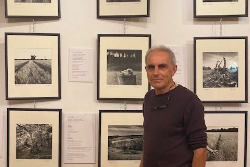 David standing in front of his photos in the Progress Theatre foyer