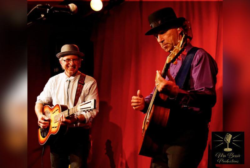 Musicians Tyzack & Tortora in front of a red curtain