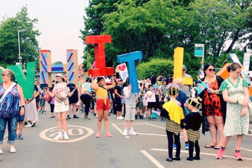 People at Whitley Carnival holding up giant letters spelling W H I T L E Y