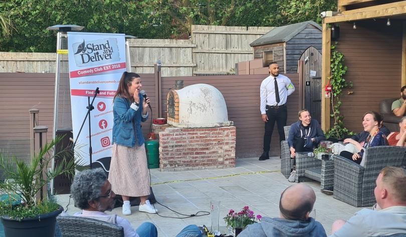 A picture the Stand and Deliver logo on a cinema screen 