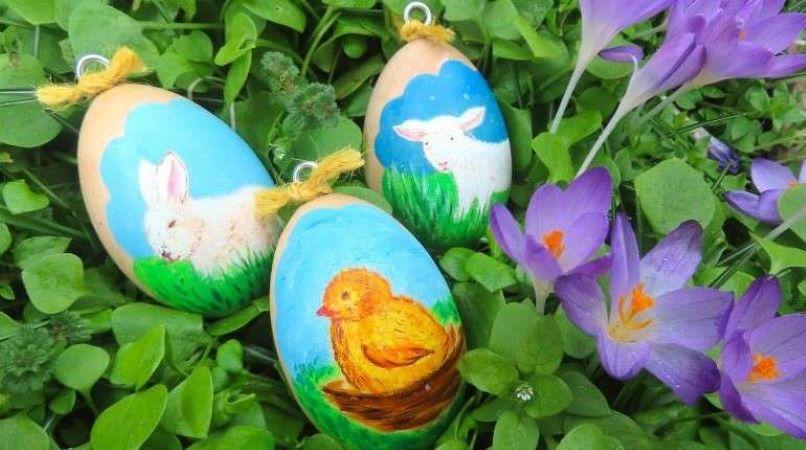 Painted Easter eggs lying in grass and flowers