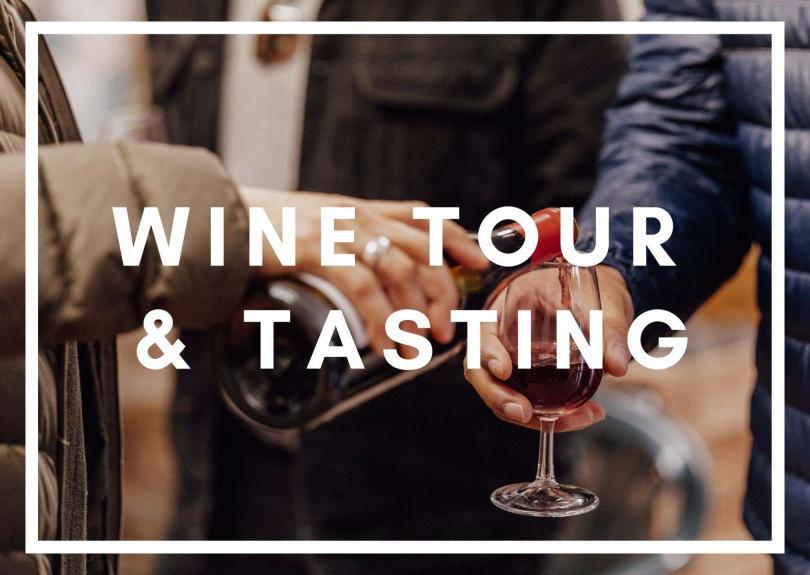 Close up of a bottle of red wine being poured into a glass, white bold text over the front of the image reads "Wine Tour & Tasting"