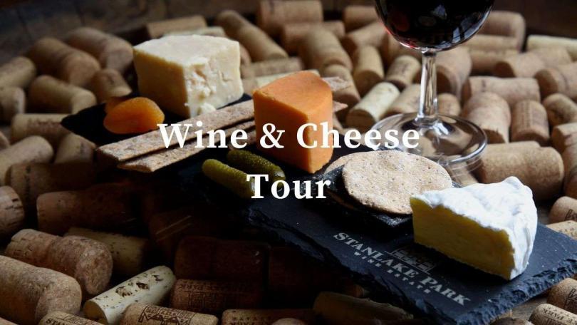 Wine and Cheese on a slate board, white text over the front saying Wine & Cheese tour