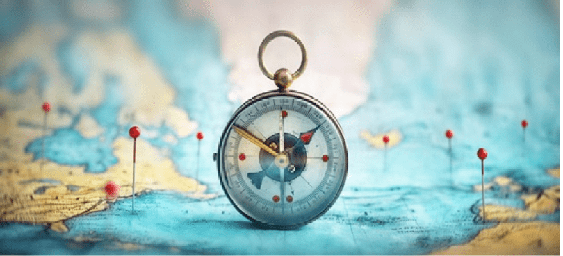 Image of a map with pins marking places. In the centre of the map is a compass.