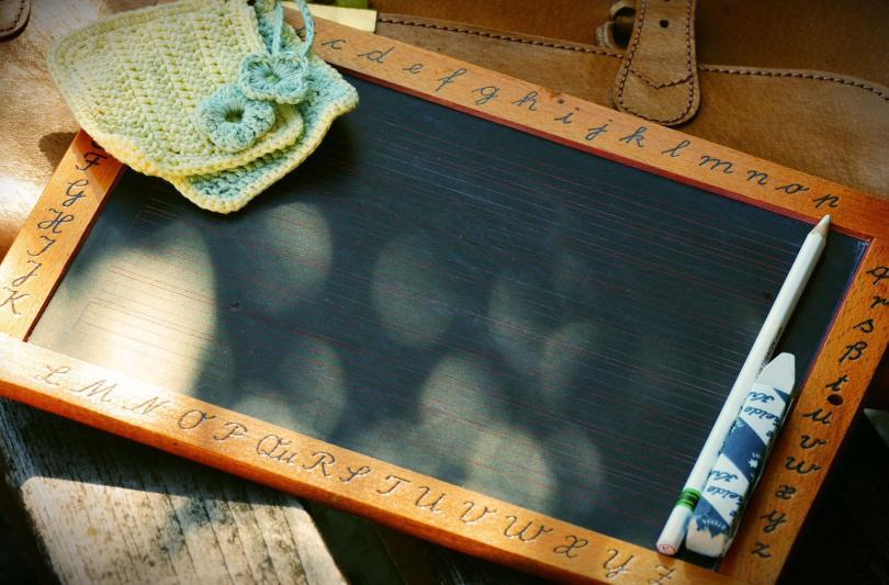 Slate board with a piece of chalk