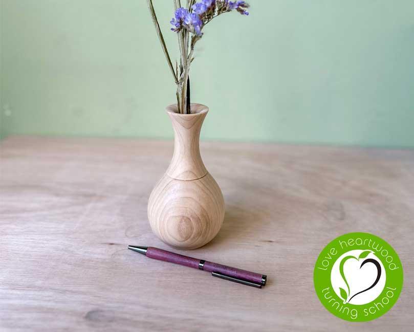 Wooden bud vase and a wooden pen made from purpleheart wood.