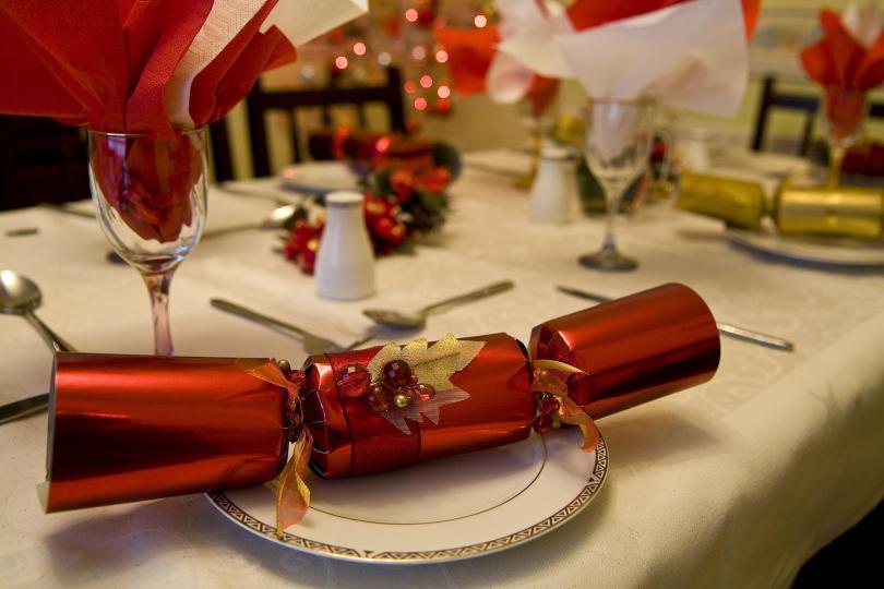a laid Christmas table with crackers
