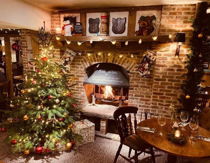 Christmas tree by a wood fire in the Cunning Man pub