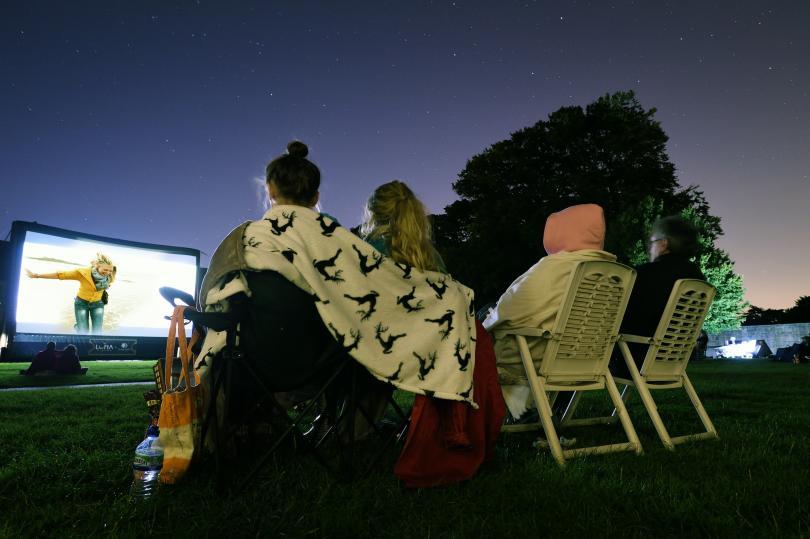 People watching outdoor cinema at Basildon Park