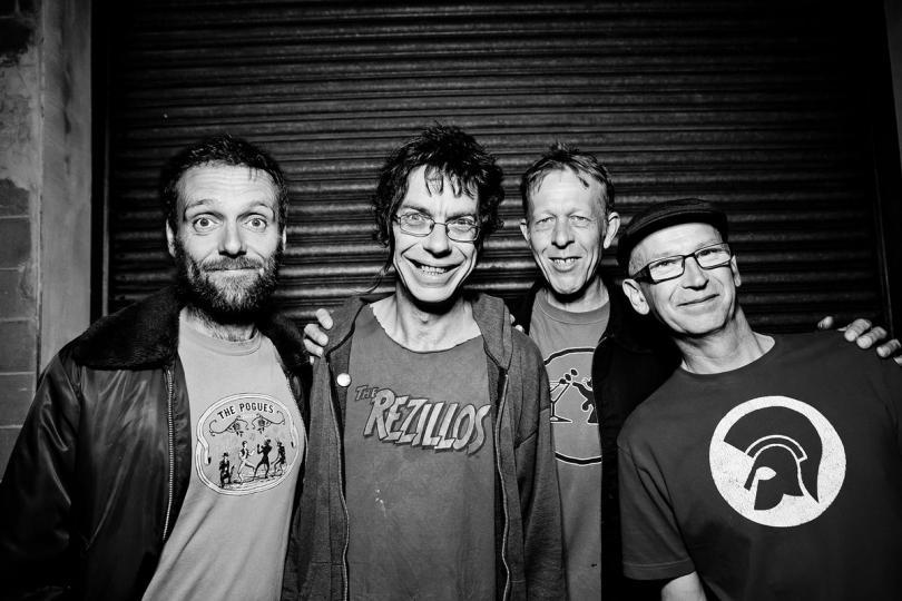 Four middle-aged punks in black and white