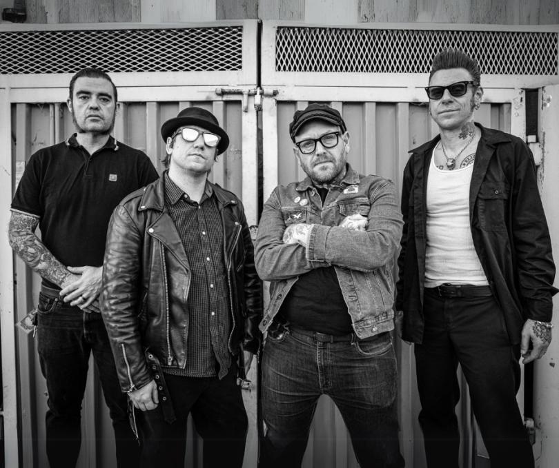 four middle-aged punks in black and white