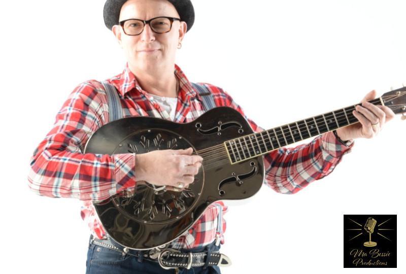 Singer Eddie Martin holding a steel guitar