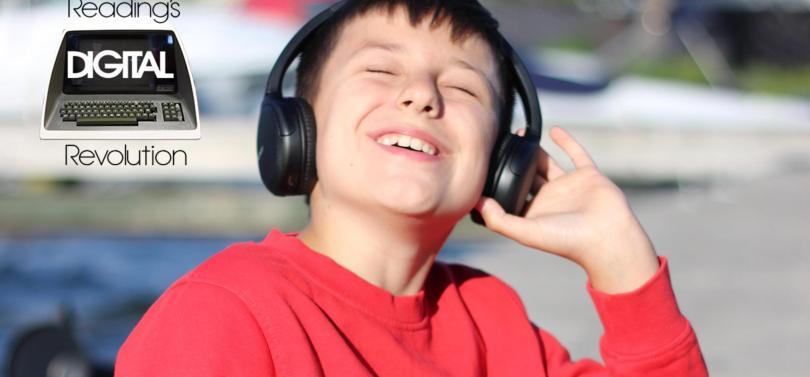 Child wearingn headphones and grinning