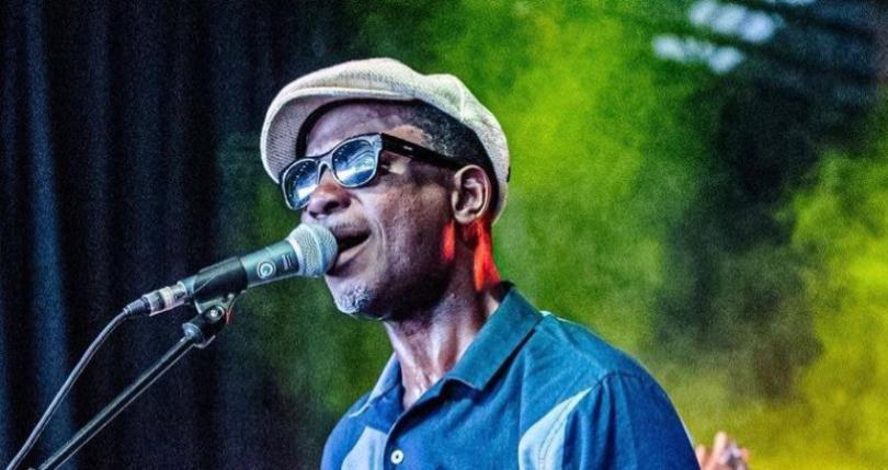 bluesman Errol Linton singing into a microphone