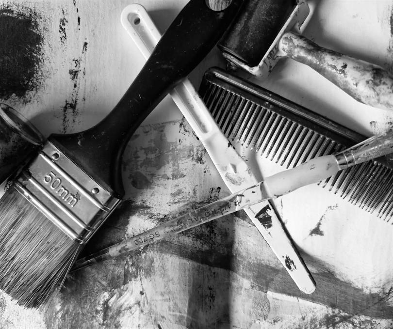 Black and white photo of art equipment - paintbrushes, clay tools and the like