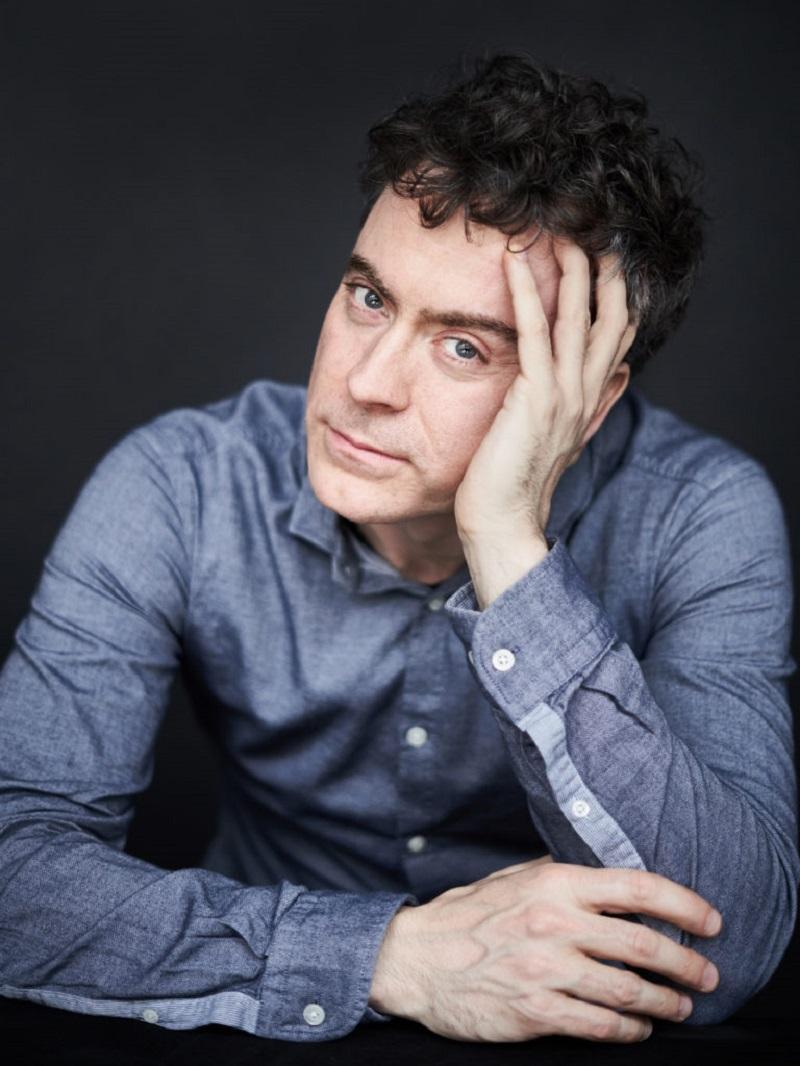 Paul Lewis leaning his head on one hand