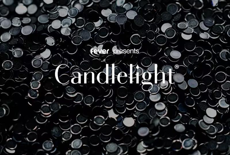 The word "candlelight" over an image of black, shimmering beads