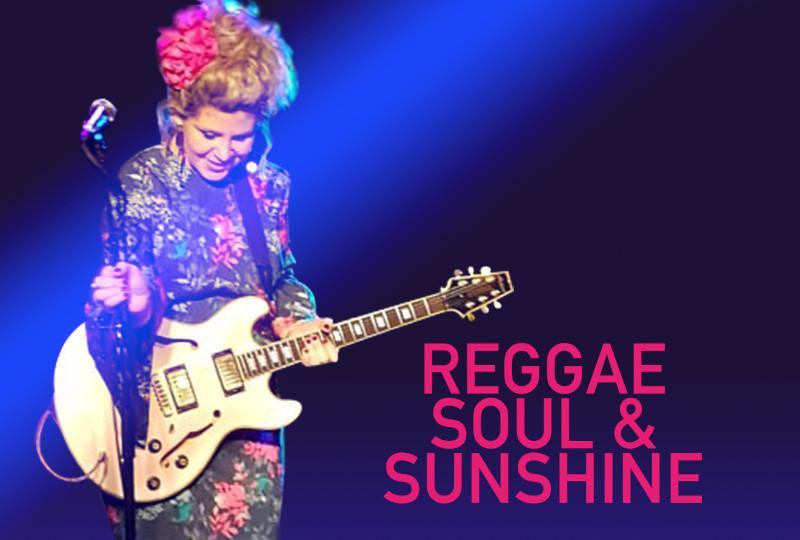 Singer Jewels Vass with a guitar on a purple background