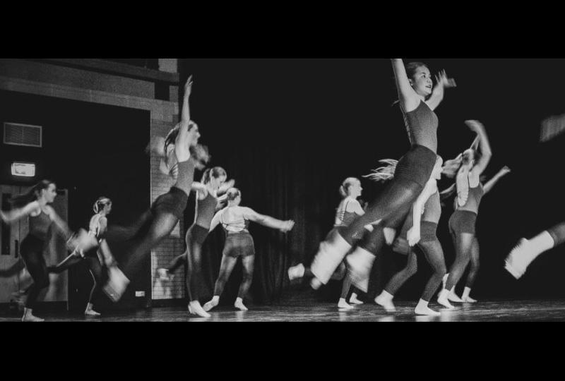 black and white photo of several young female dancers jumping