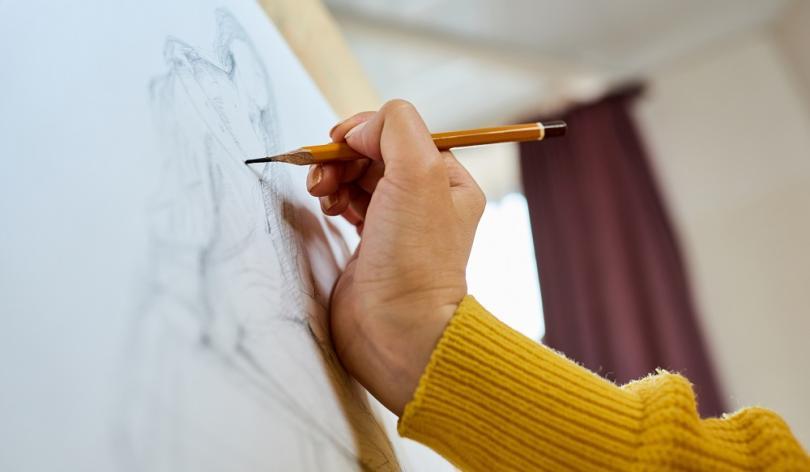 Hand sketching a person