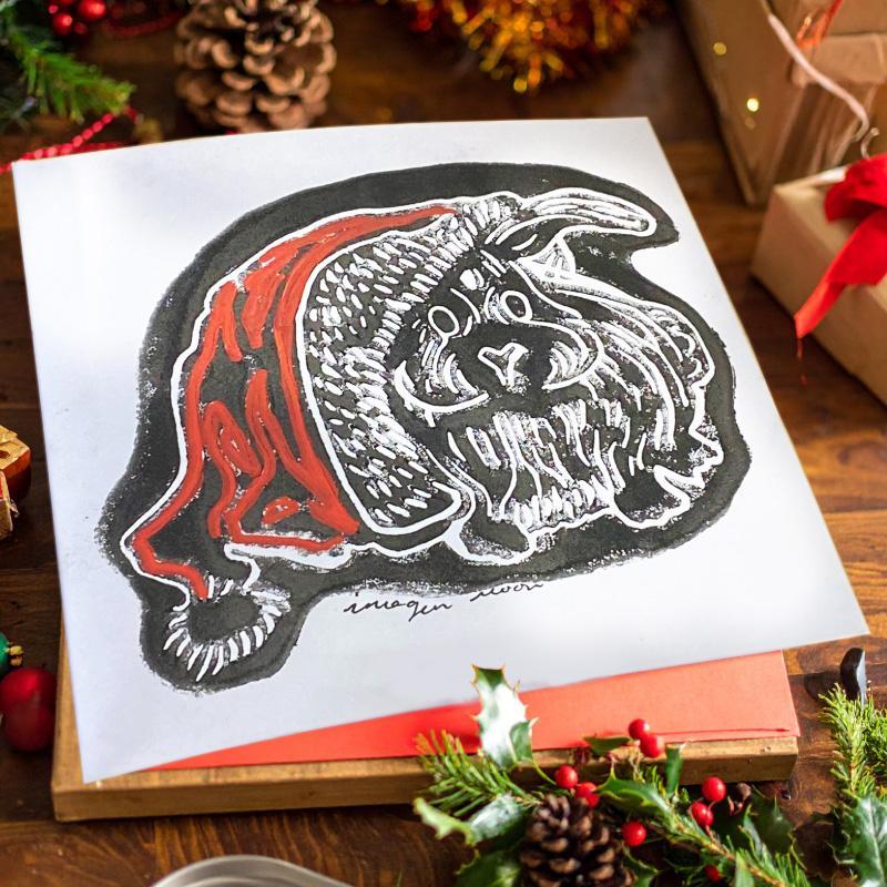 Rabbit with Christmas hat made with linoleum