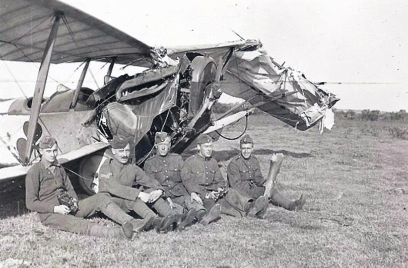 Royal Flying Corps Airmen sitting by their plane