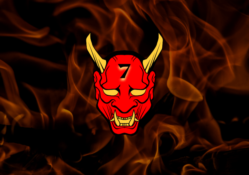 Dark flame background. Red cartoon image of devil, with sharp yellow fangs, yellow eyes and long yellow horns. Number "7" on forehead.
